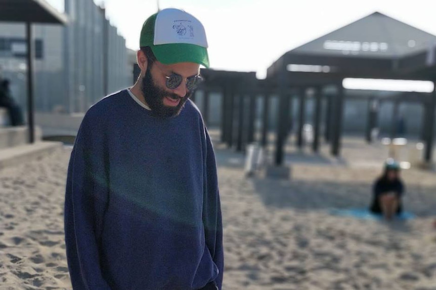 Adiel Cohney walks along a beach in Israel.