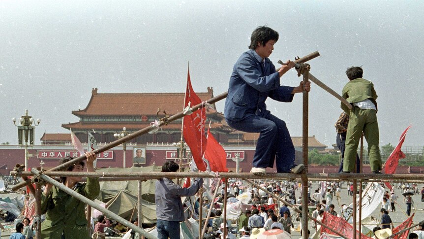 Student protesters construct a tent to protect them from the elements in Tiananmen Square.