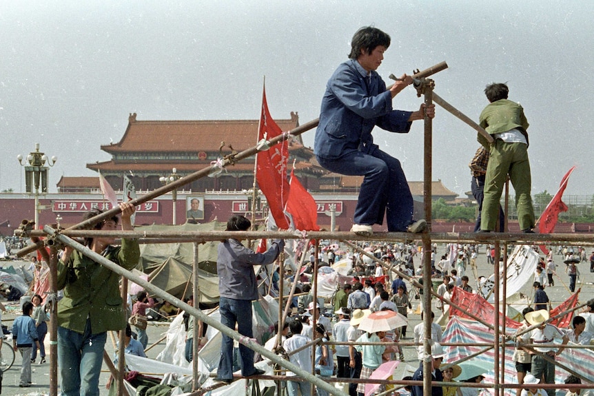 Student protesters construct a tent to protect them from the elements in Tiananmen Square.