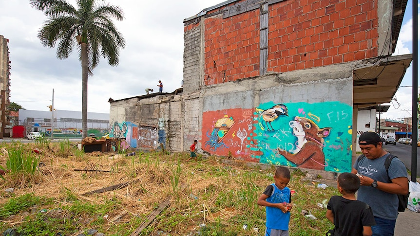 Young children play on buildings and in vacant lots with handmade toys in El Chorrillo.