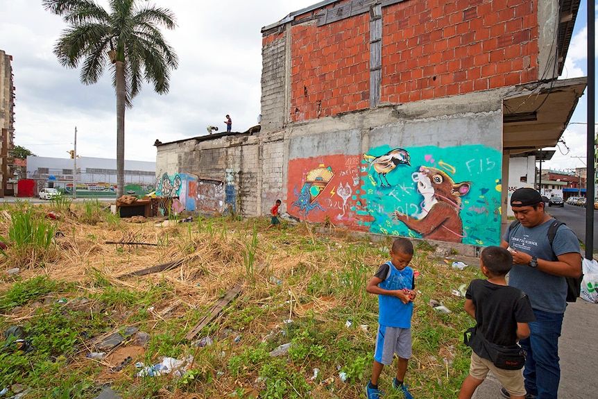 Young children play on buildings and in vacant lots with handmade toys in El Chorrillo.