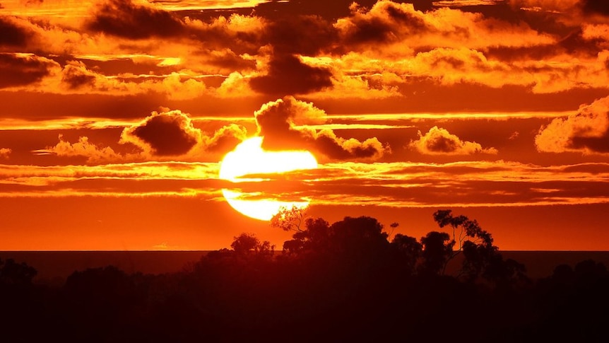 A brilliant red sunset among clouds over Adelaide, 2013.