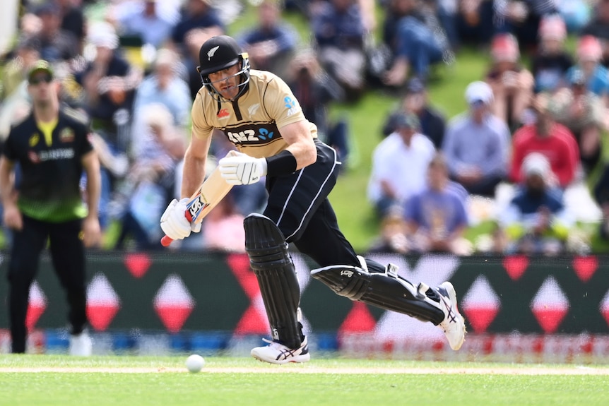 Martin Guptill sets off for a ruin, holding his bat in both hands