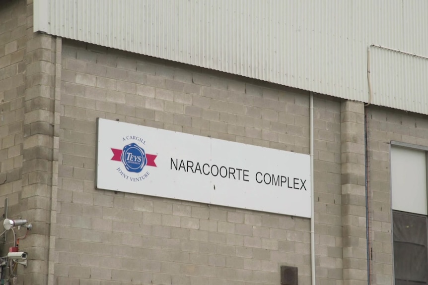 A sign on the outside of a grey brick building reading 'Teys Australia Naracoorte Complex'.