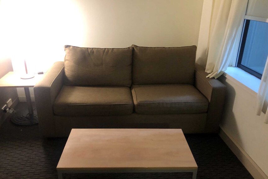 A sofa in a hotel room.