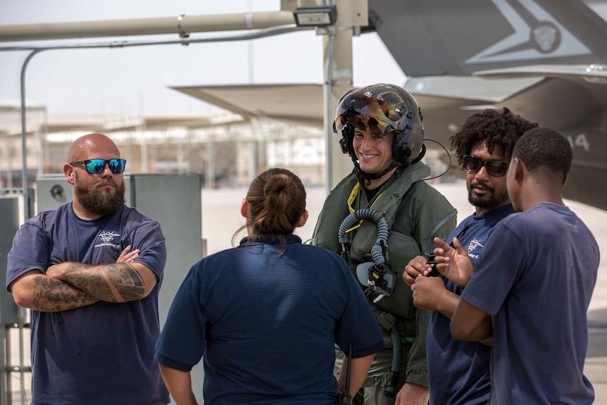 Flight Lieutenant Ross Bowman (centre), with Lockheed Martin maintenance personnel