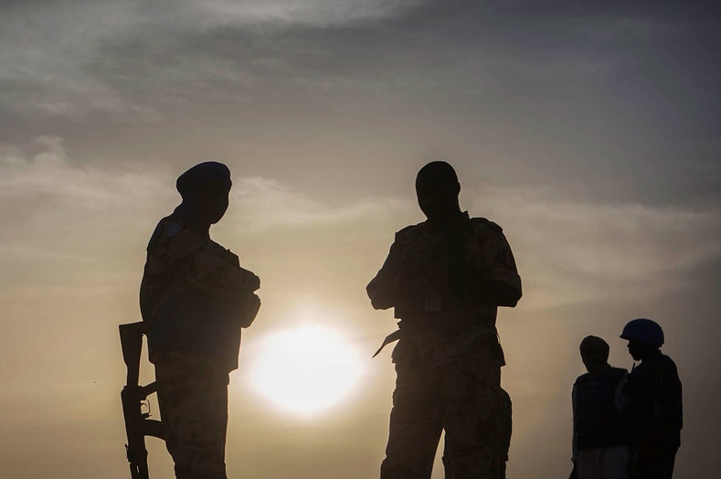 Stillhouse of four Chadian peacekeepers in Mali in front of a setting sun