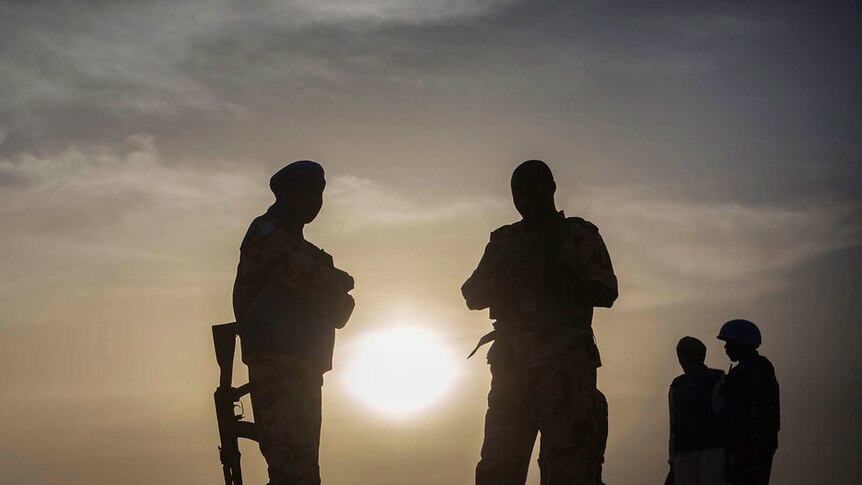 Stillhouse of four Chadian peacekeepers in Mali in front of a setting sun
