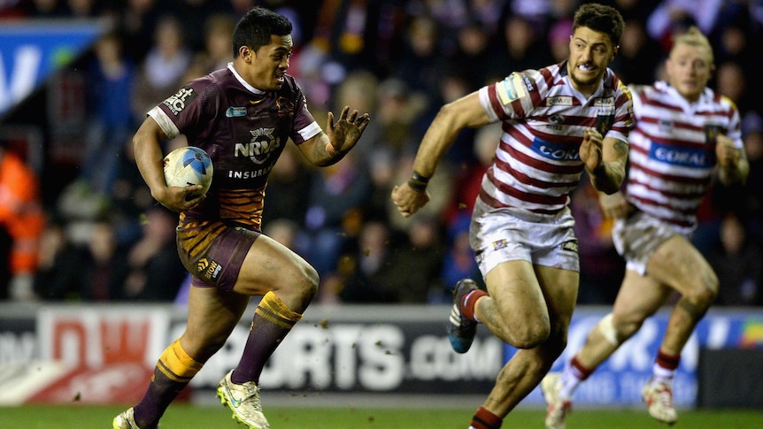 Brisbane's Anthony Milford makes a break against Wigan's Anthony Gelling in the World Club Series.