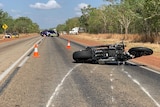 A motorbike lies on the road