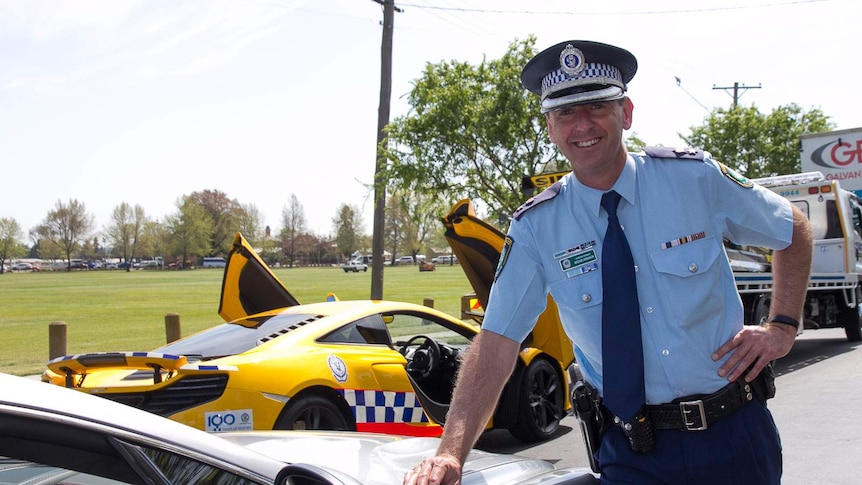 Bathurst region commander, Michael Robinson, with police sports cars in town for the Bathurst 1000
