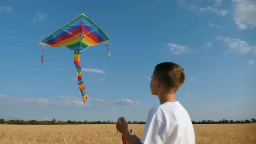 A boy flying a kite