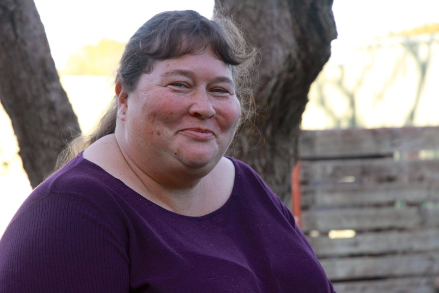 Ms Brown seated in the centre's garden