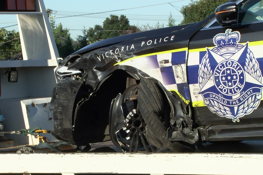 A Victoria Police highway patrol car, with a crumpled front and blown-out wheel.