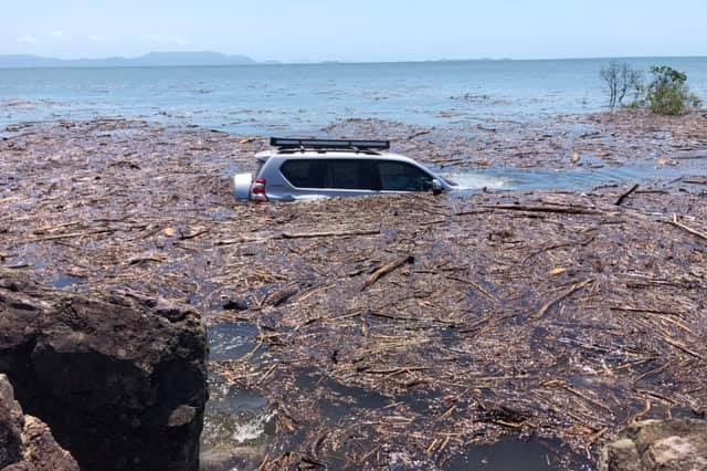 4WD is submerged at Midge Point after a king tide.