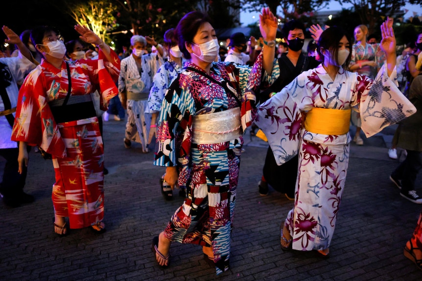 Women in summer kimonos and masks.