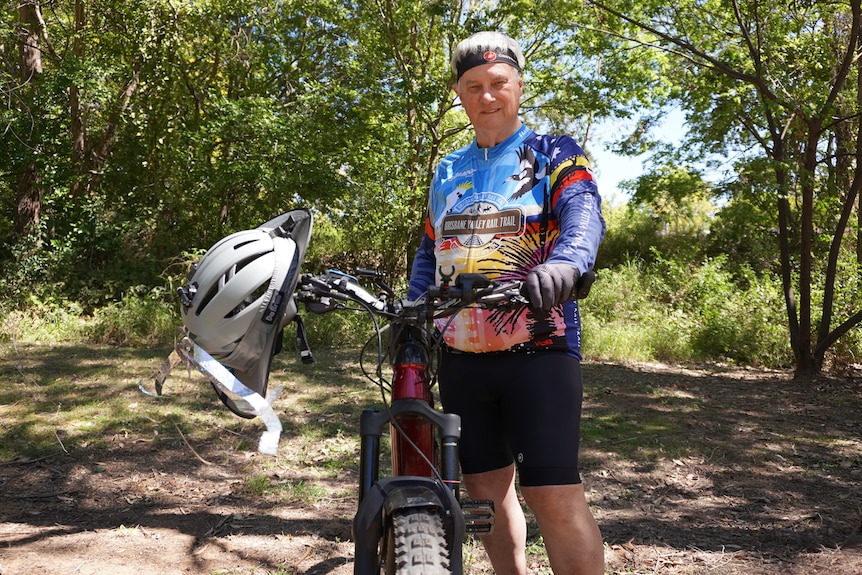 A man wearing lycra standing next to his bike