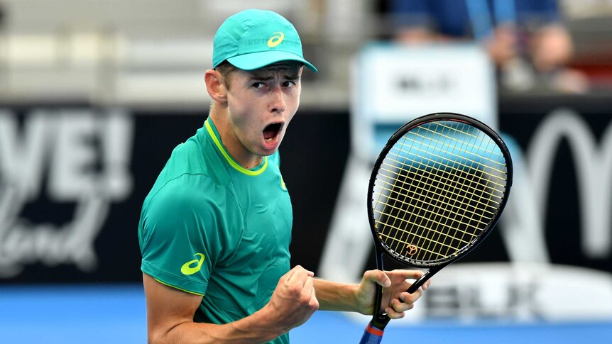 Alex De Minaur pumps his right fist as he celebrates winning the first set against Michael Mmoh at the Brisbane International.