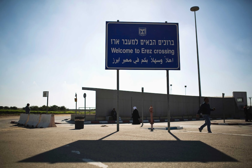A wide view of a crossing point between Israel and Gaza shows a sign saying "Welcome to Erez crossing".