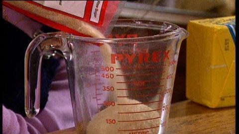 Sugar pours into measuring jug
