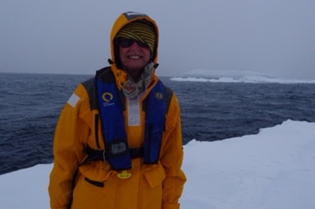 Retiree Gwen Davis-Goff poses on a glacier in Antarctica.
