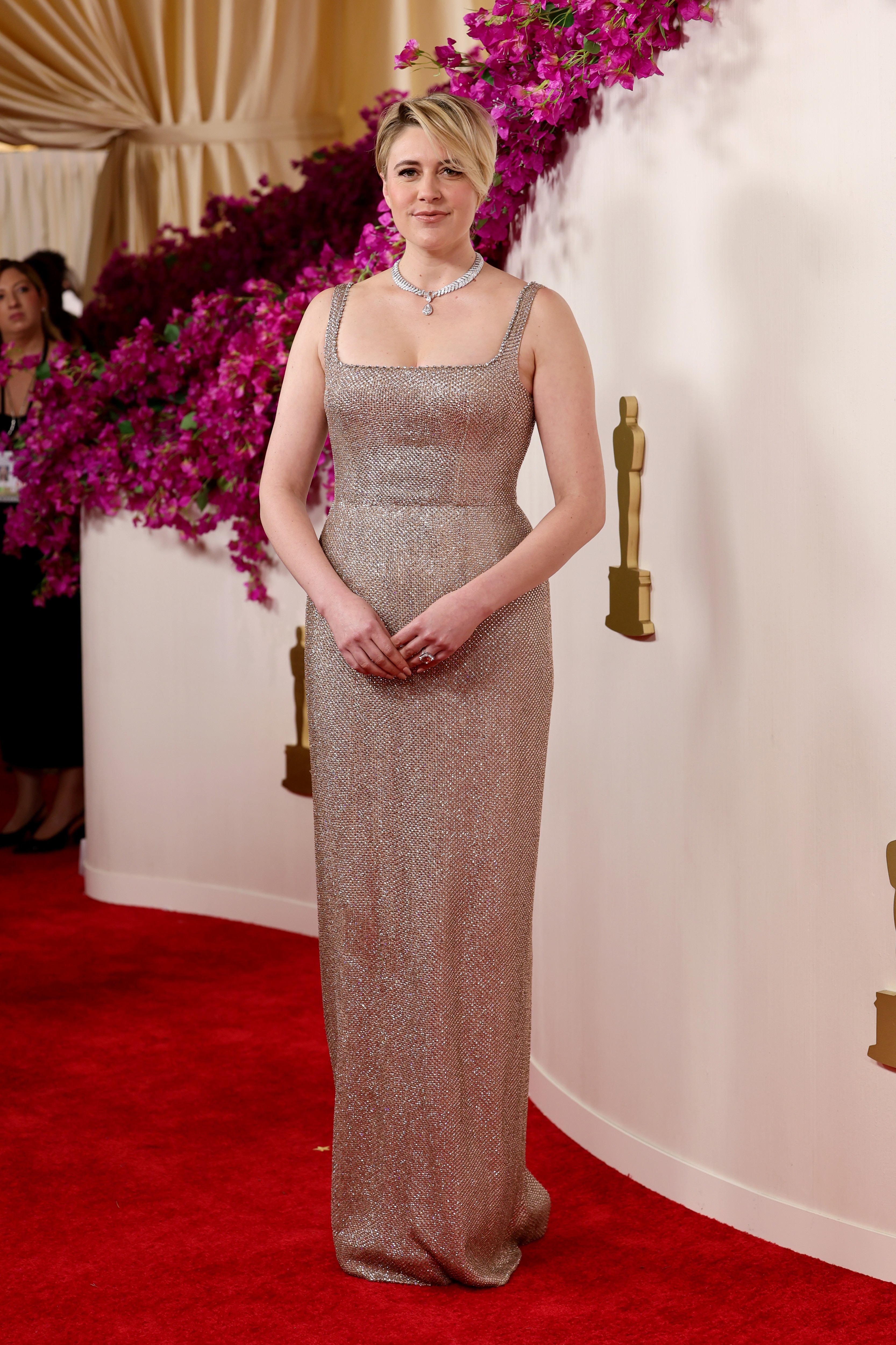 Greta Gerwig poses on tthe red carpet at the 2024 Oscars.