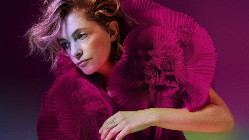 Singer Alison Goldfrapp wearing a large pink fabric boa