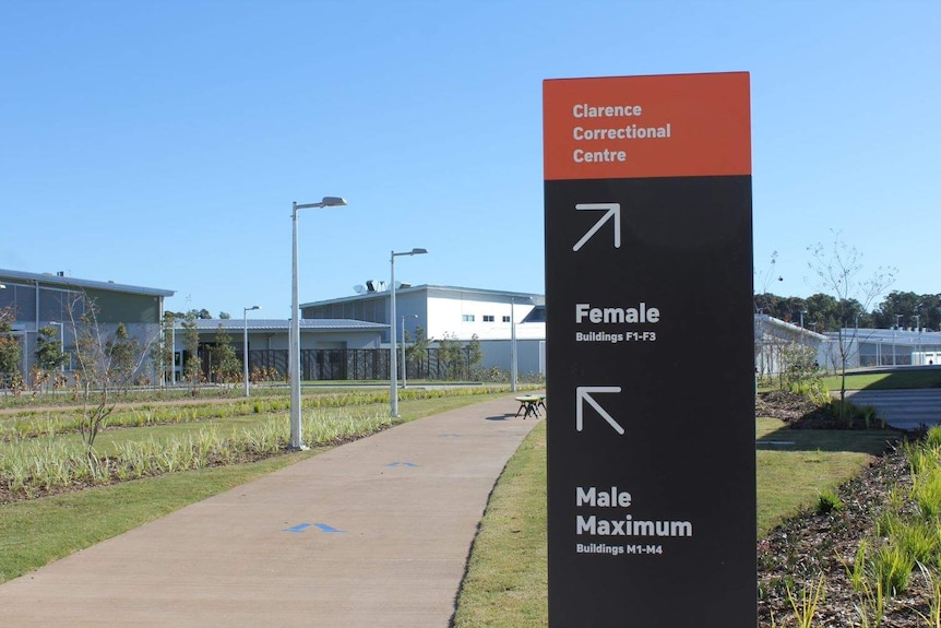 A sign by the footpath shows where male and female prisoners should go at the new Clarence Correctional Centre.