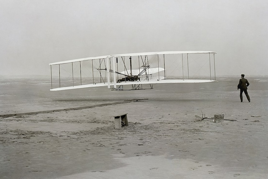 Black and white image of the first successful plane flight