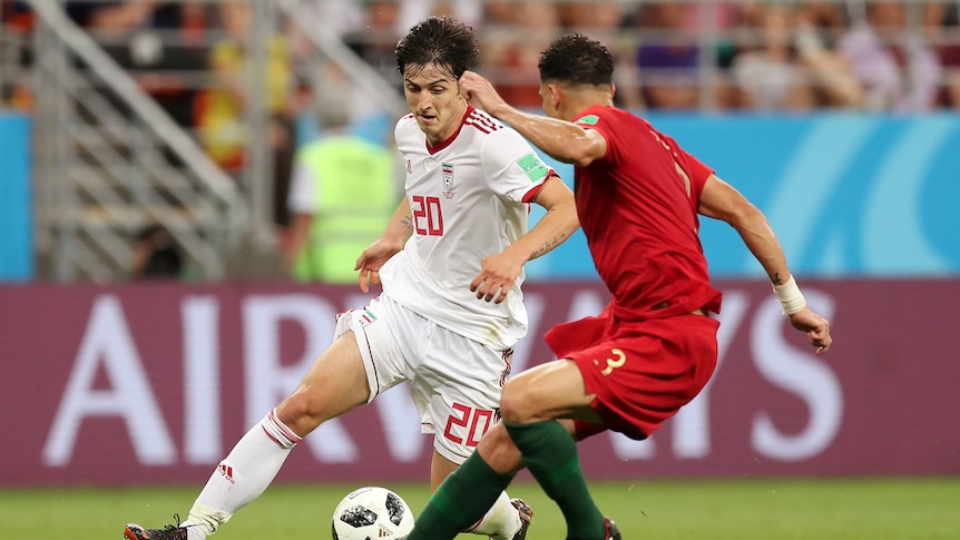 Sardar Azmoun runs with the ball for Iran