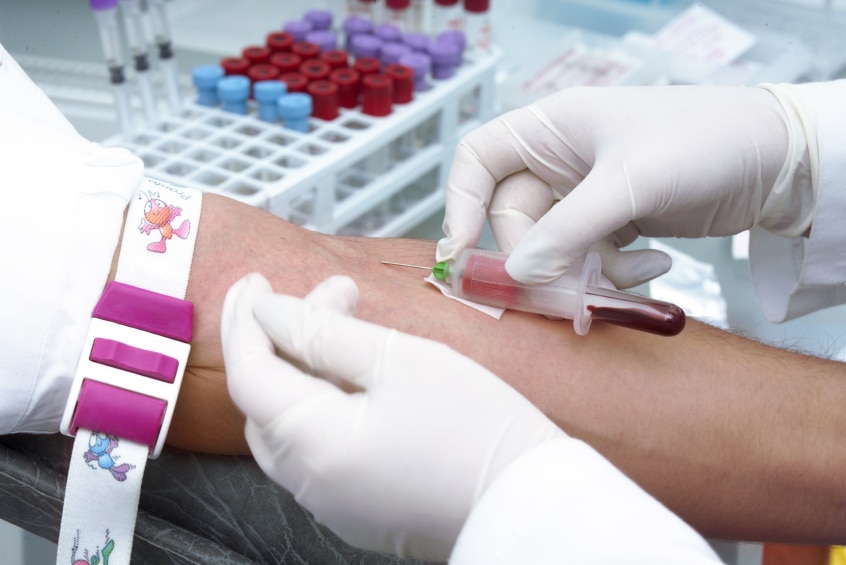 A person having a sample of blood taken for a clinical trial.