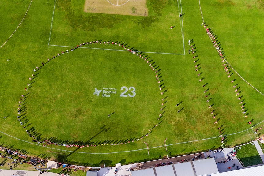 An aerial shot of a group of people in a cricle.