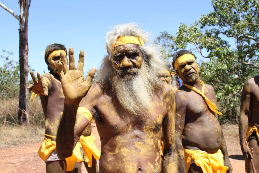 Aboriginal men in traditional body paint stand together