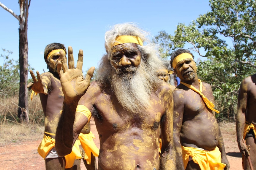 Aboriginal men in traditional body paint stand together