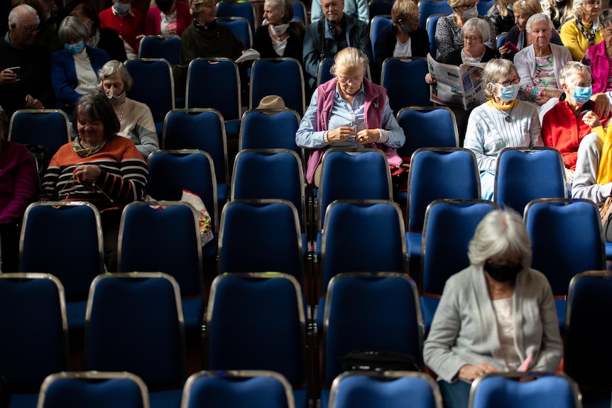 Rows of seats with about a third filled with older people