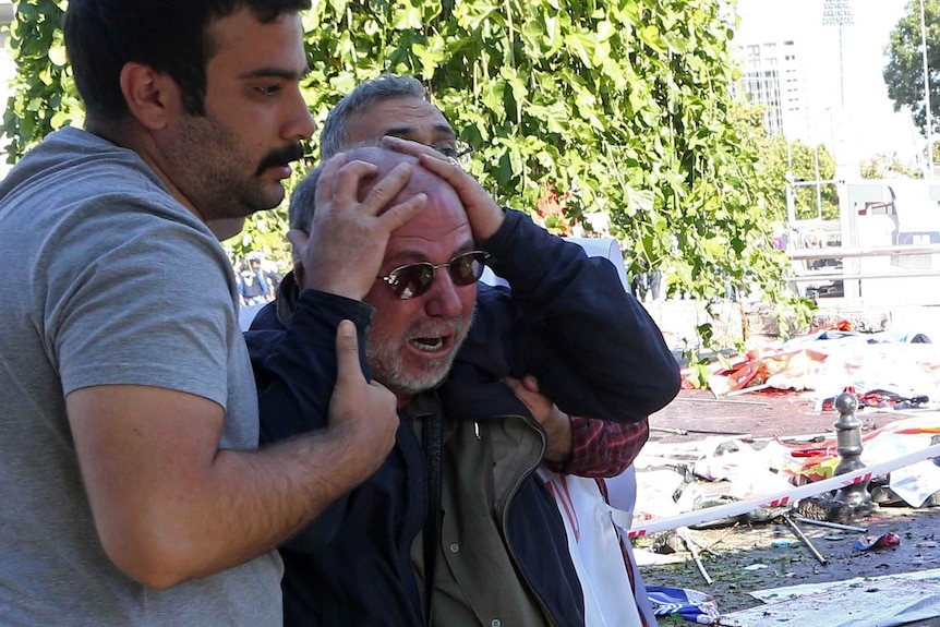 A man is being helped after bombs were set off at a peace rally in Ankara, October 10, 2015.