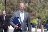 WA Transport Minister Dean Nalder holding a briefcase as he walks into a Cabinet meeting