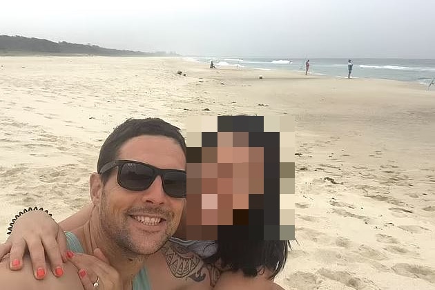 a man and a woman smiling on a beach