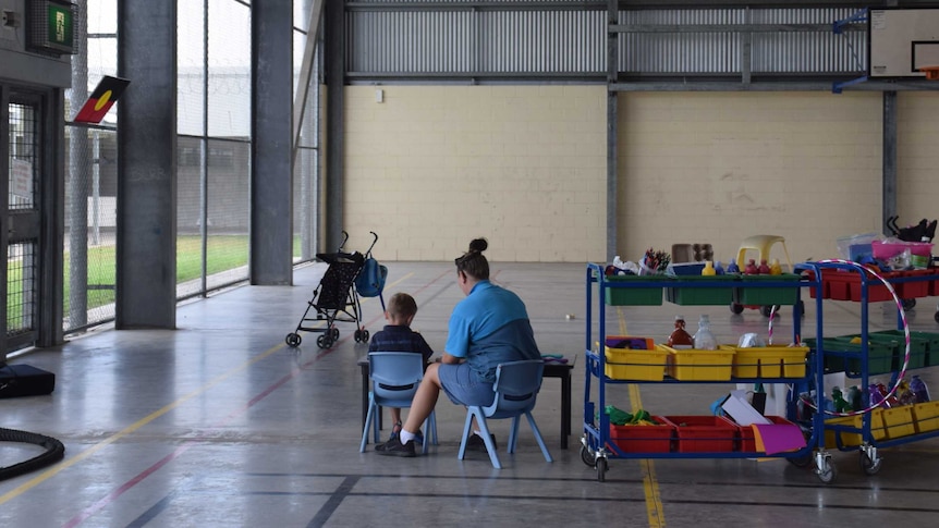 Mother and her son working on art in a big hall at the Townsville Correctional Centre