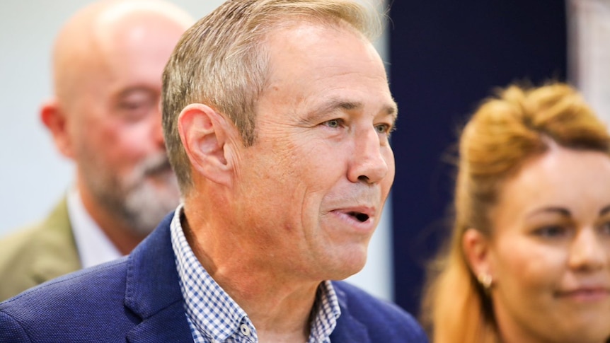 A close-up photo of Roger Cook speaking.