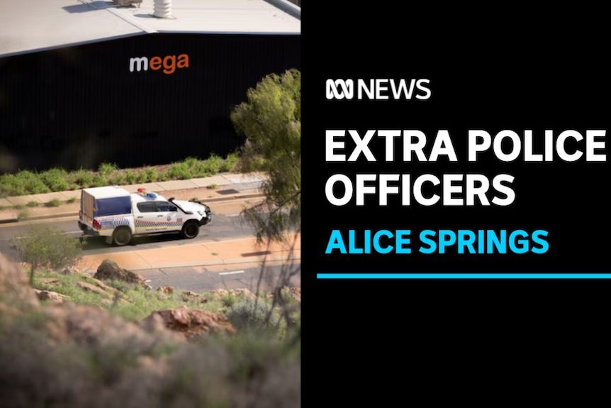 Extra Police Officers, Alice Springs: A police vehicle drives along a road with a large building with 'mega' sign.