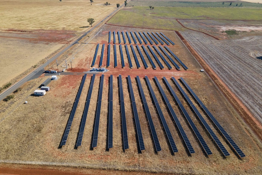 A drone image of the solar arrays at a solar farm in the countryside