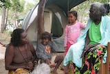 Yolngu elders Djapirri Mununggirritj (left) and Dhanggal Gurruwiwi talk with children