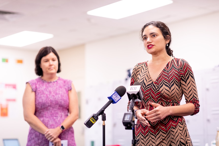 Lauren Moss talks at a press conference as Natasha Fyles watches on.