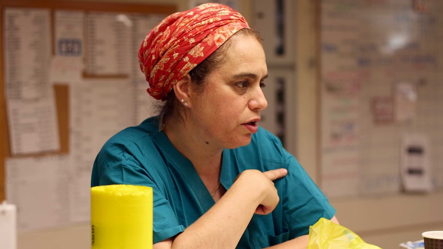 Daphna Strassberg at work in the ward, dressed in surgical greens.