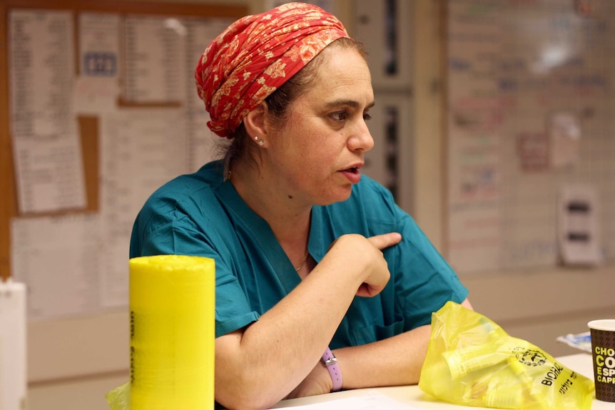 Daphna Strassberg at work in the ward, dressed in surgical greens.