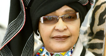Winnie Madikizela-Mandela wearing a head scarf and sunglasses.
