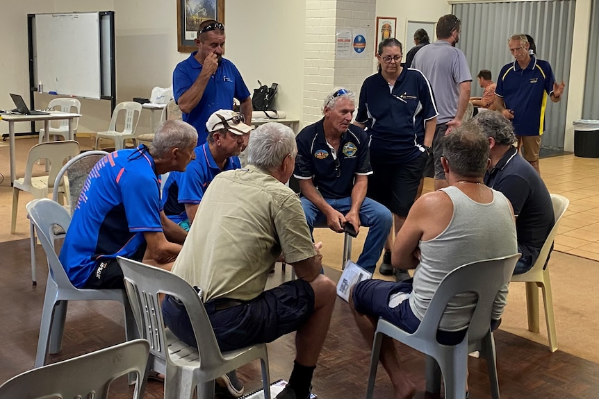 Group of people sit in circle talking