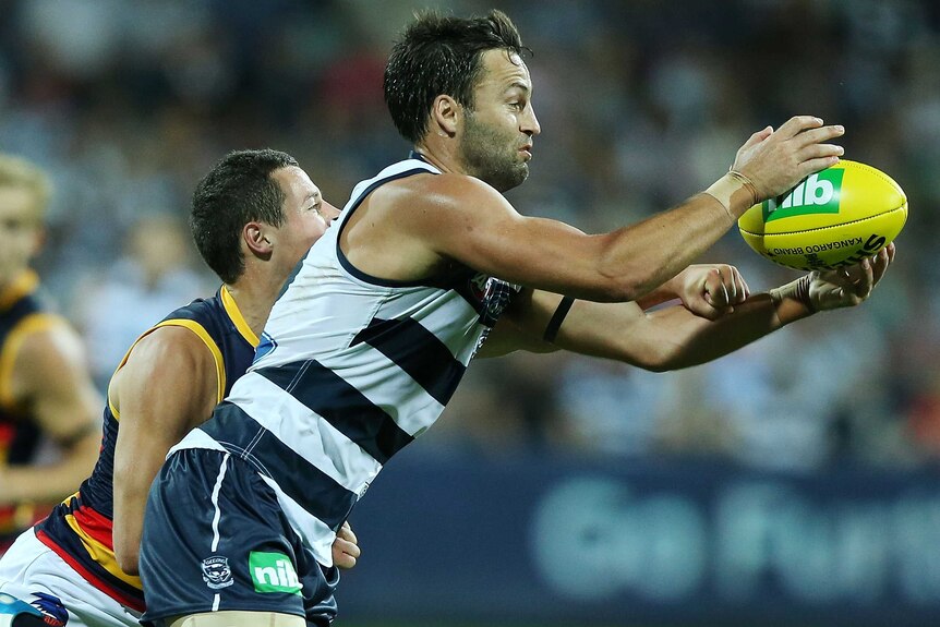 The Cats' Jimmy Bartel marks the ball during the round one match with Adelaide.