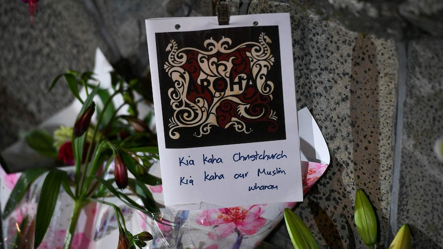 A card saying "Kia kaha Christchurch, Kia kaha our Muslim wharau".